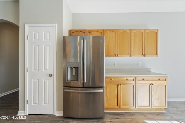 kitchen featuring stainless steel fridge with ice dispenser, light brown cabinets, and wood-type flooring