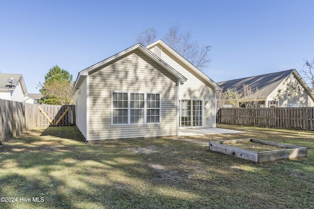 back of property featuring a lawn and a patio