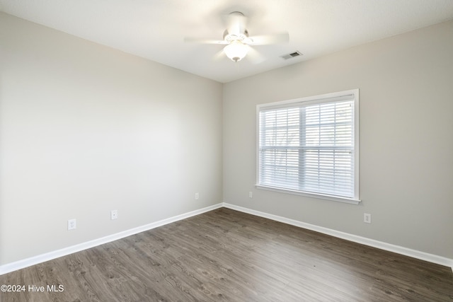 empty room featuring ceiling fan and dark wood-type flooring