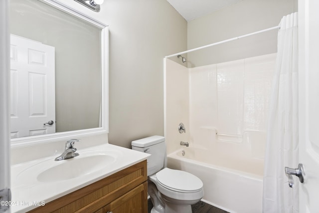 full bathroom with vanity, shower / tub combo, and toilet