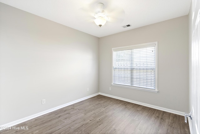 spare room with hardwood / wood-style floors and ceiling fan