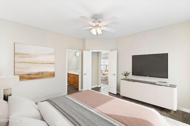 bedroom featuring dark hardwood / wood-style floors, ceiling fan, and connected bathroom