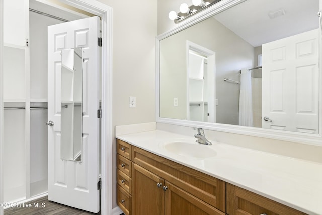 bathroom featuring vanity and hardwood / wood-style flooring