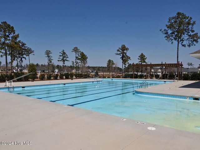 view of swimming pool featuring a patio area