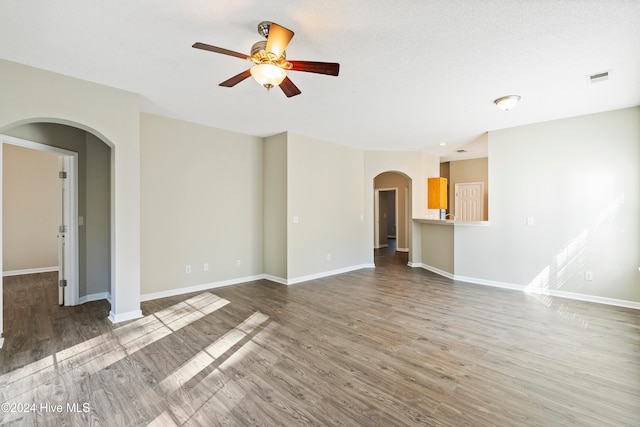 unfurnished living room with ceiling fan and hardwood / wood-style floors