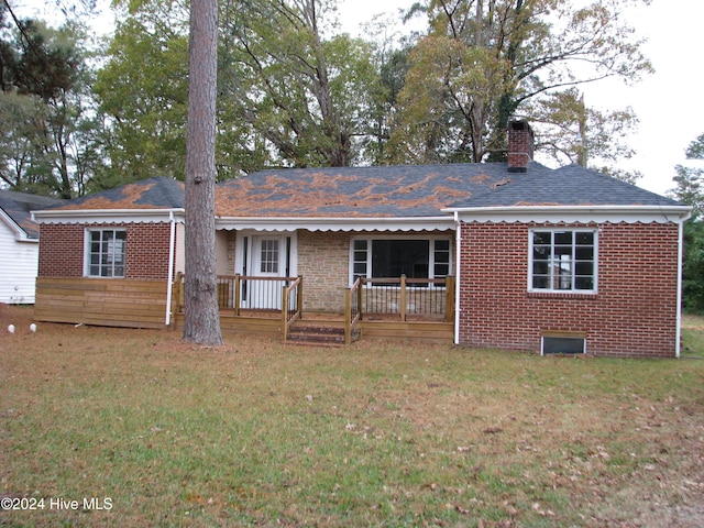 rear view of house with a yard and covered porch