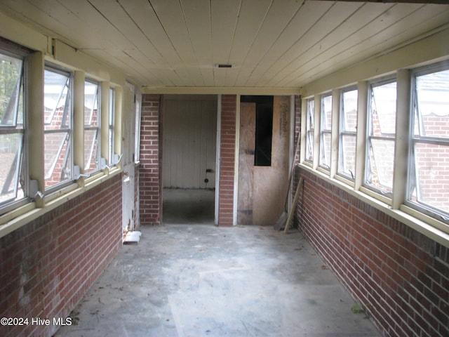 unfurnished sunroom featuring wooden ceiling