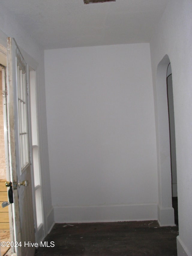 spare room featuring dark wood-type flooring