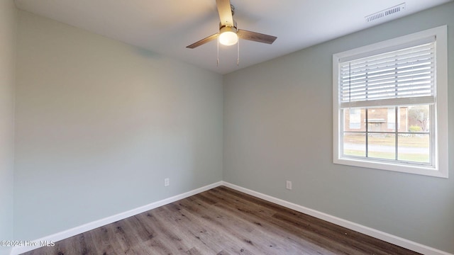 empty room featuring hardwood / wood-style flooring and ceiling fan