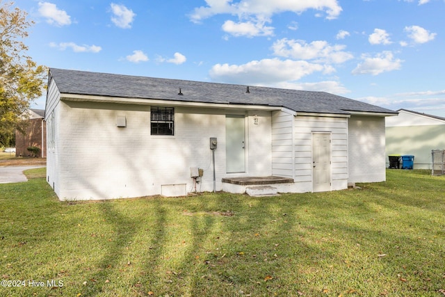 back of property featuring a lawn