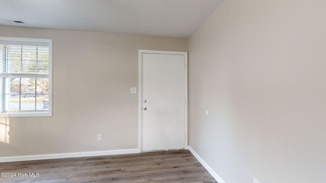 spare room with hardwood / wood-style flooring