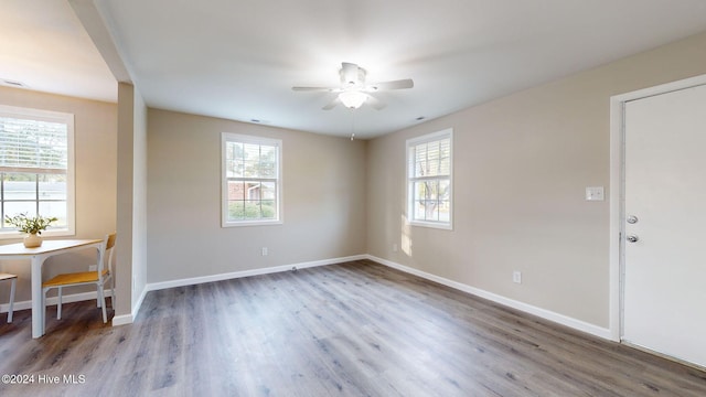 spare room with hardwood / wood-style floors, ceiling fan, and a wealth of natural light