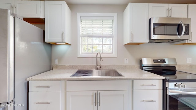 kitchen featuring white cabinetry, sink, and stainless steel appliances