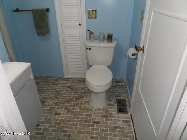 bathroom featuring vanity, toilet, and washer / clothes dryer