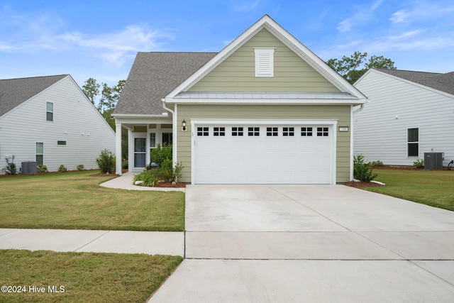 view of front facade featuring central AC unit, a front yard, and a garage