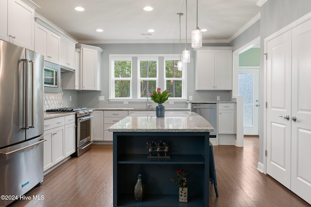 kitchen featuring premium appliances, open shelves, ornamental molding, a sink, and white cabinetry