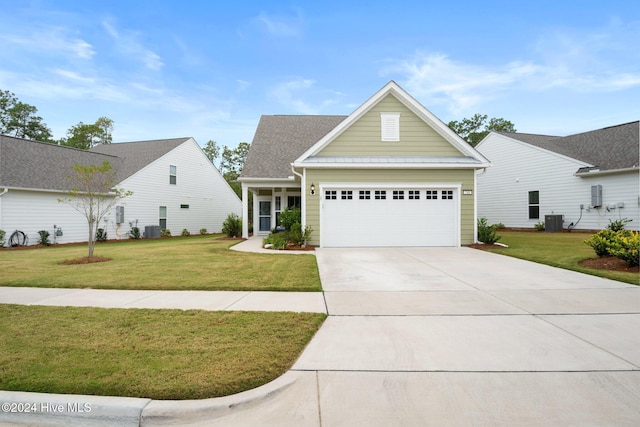 view of front of house with a garage, a front lawn, and central air condition unit