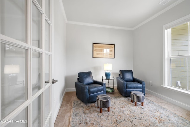 living area featuring ornamental molding and carpet