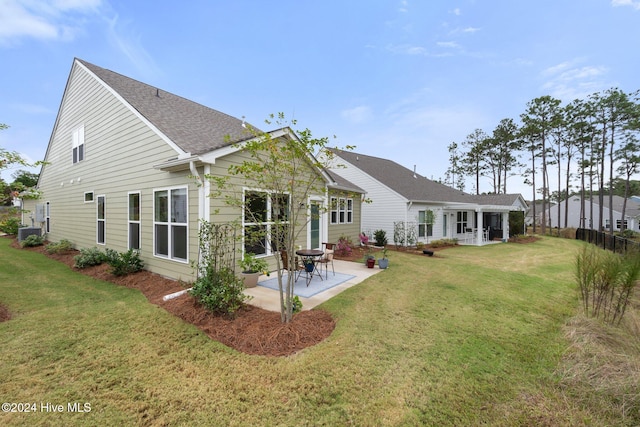 rear view of house featuring central air condition unit, a patio area, and a lawn