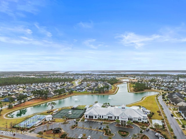view of property location featuring a nearby body of water and nearby suburban area