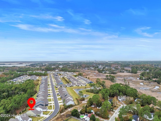 view of property location featuring nearby suburban area and a large body of water