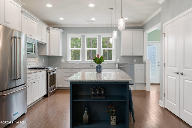 kitchen with white cabinetry, high end appliances, light stone countertops, and a center island