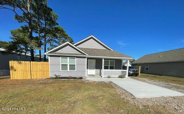 view of front of home featuring covered porch and a front lawn