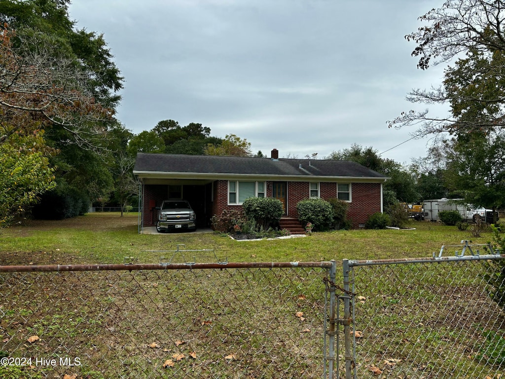 ranch-style house with a carport and a front yard