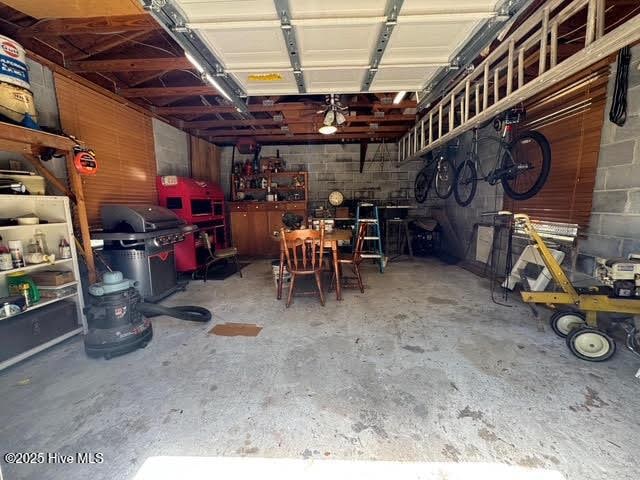 garage with a workshop area and concrete block wall