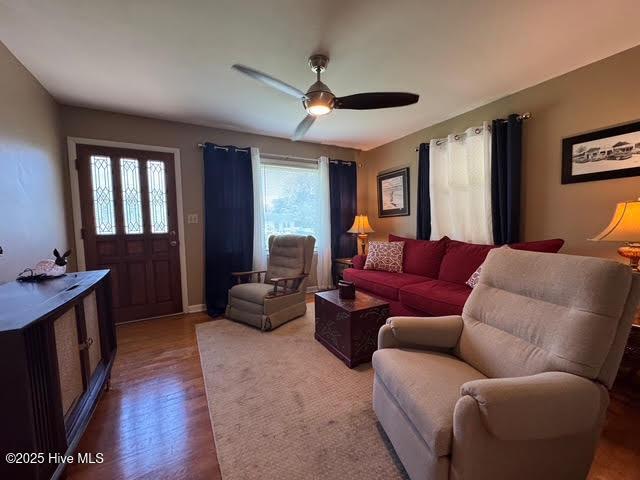 living area featuring wood finished floors and ceiling fan