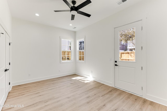 entrance foyer with a healthy amount of sunlight, light wood-style flooring, and visible vents