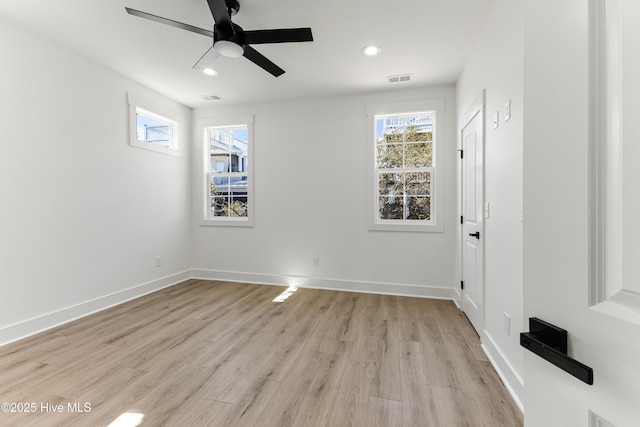 empty room with recessed lighting, visible vents, light wood-style flooring, and baseboards