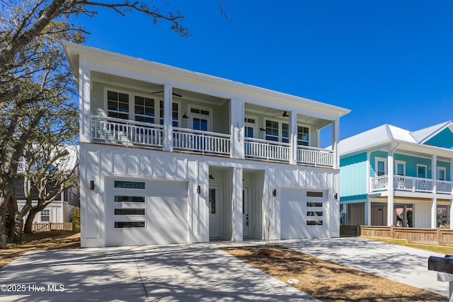 view of front facade featuring driveway, board and batten siding, ceiling fan, and an attached garage