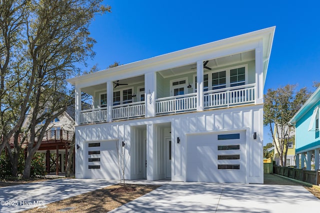 view of front facade featuring ceiling fan, concrete driveway, board and batten siding, and a garage