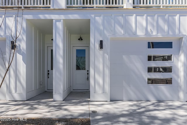 entrance to property with a garage and a balcony