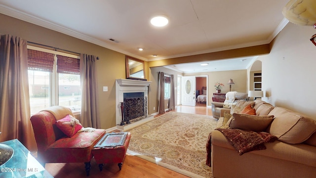 living room with wood-type flooring and crown molding