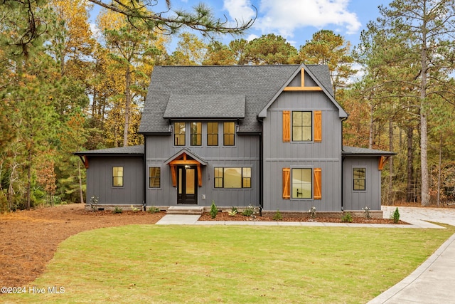 modern farmhouse style home featuring a front yard