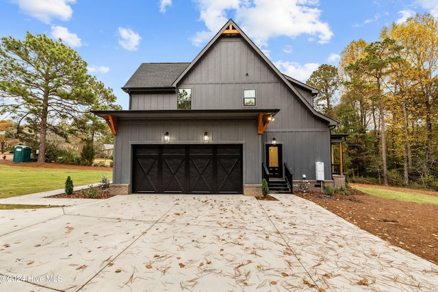 modern farmhouse featuring a garage and a front lawn