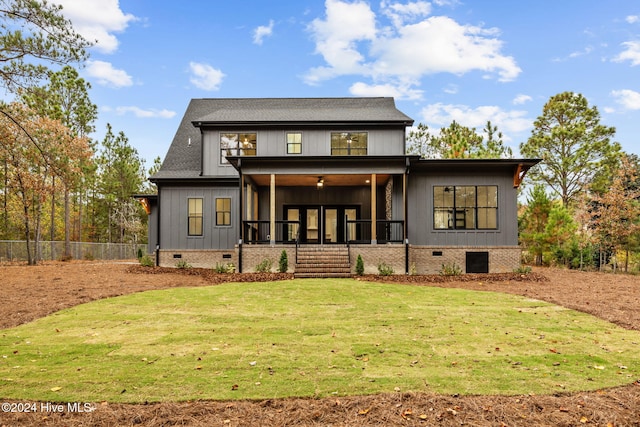 rear view of property with a porch and a yard