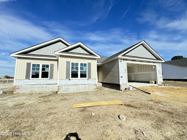 view of front facade with an attached garage and board and batten siding