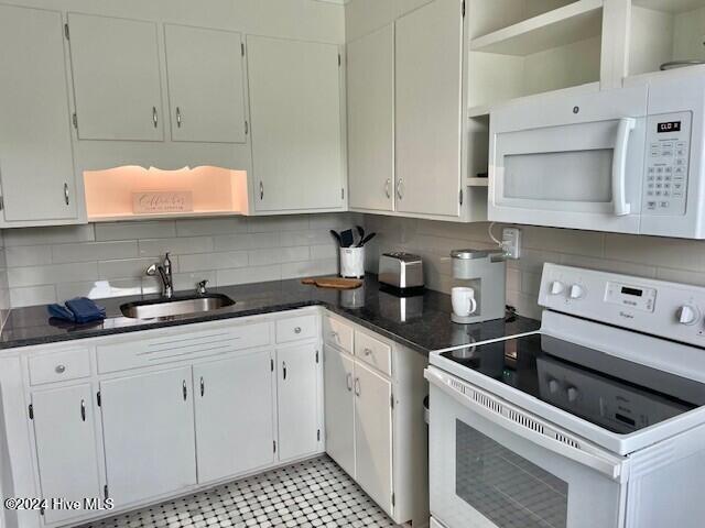 kitchen featuring white cabinetry, white appliances, sink, and tasteful backsplash