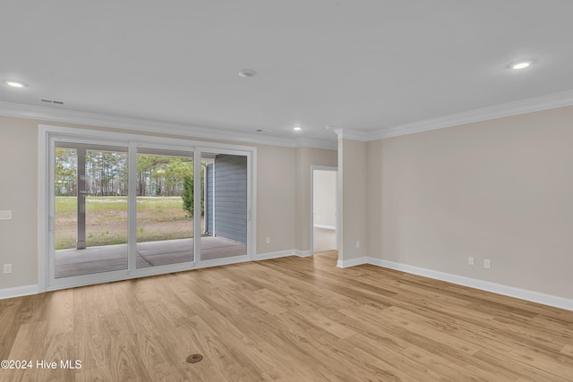 empty room with light hardwood / wood-style flooring and crown molding