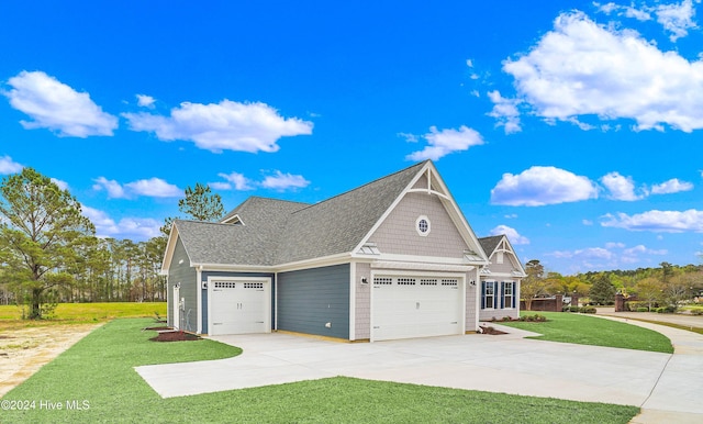 view of side of property with a lawn and a garage