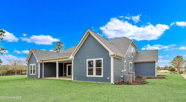 back of property with a yard and a patio