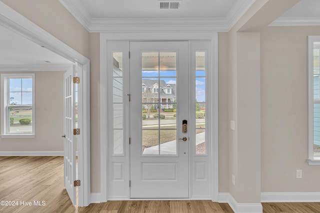 entryway featuring light hardwood / wood-style floors, plenty of natural light, and ornamental molding