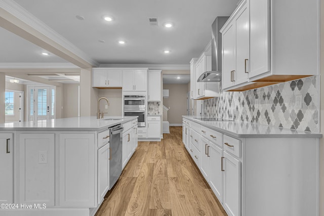 kitchen featuring sink, white cabinets, an island with sink, and appliances with stainless steel finishes