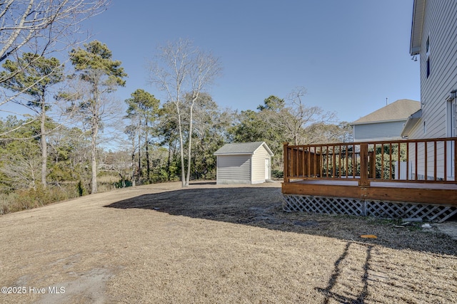 view of yard with a deck and a storage shed