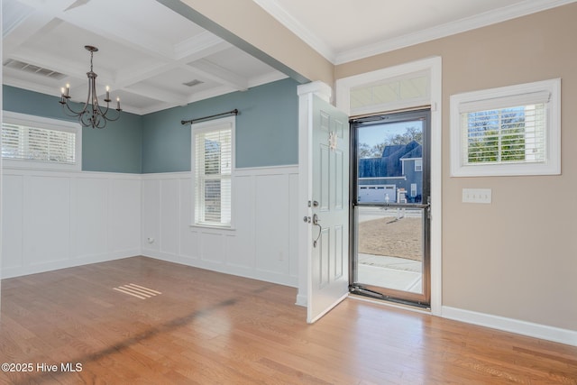 entrance foyer featuring an inviting chandelier, plenty of natural light, beam ceiling, and coffered ceiling