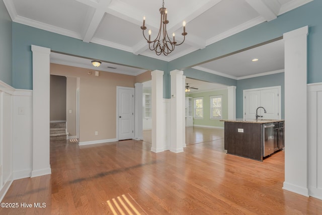 interior space featuring ceiling fan with notable chandelier, beamed ceiling, ornamental molding, light hardwood / wood-style flooring, and coffered ceiling