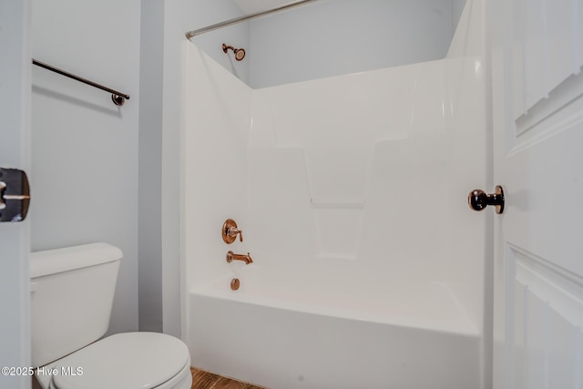 bathroom with toilet, shower / bath combination, and wood-type flooring